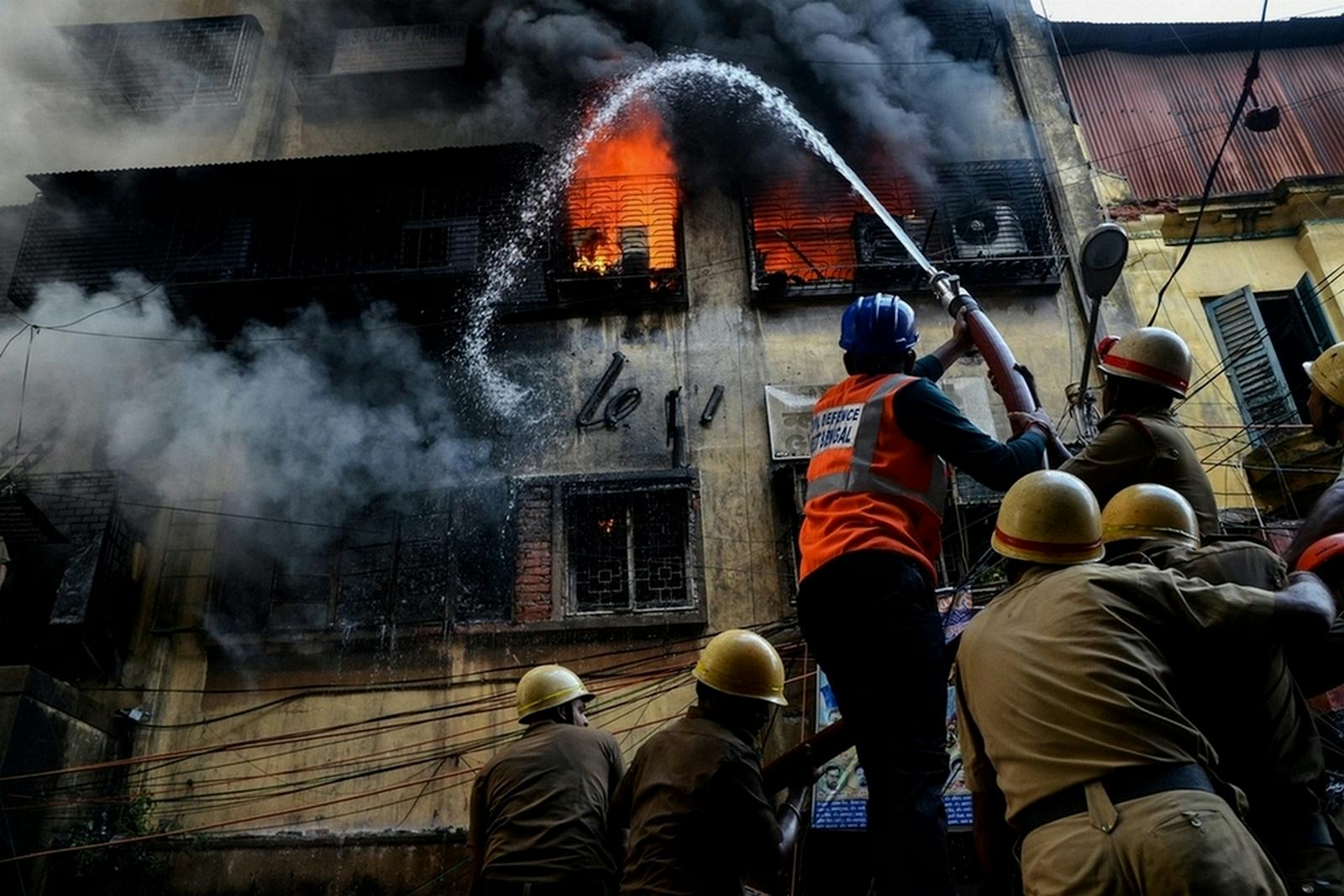 Indian firefighters battling a market fire in Kolkata