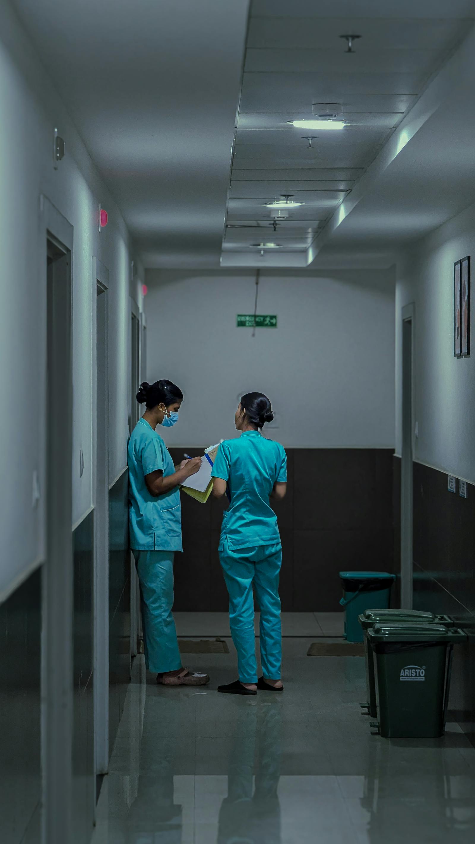 Indian nurses in scrubs walking a hospital corridor